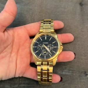Citizen men’s gold tone/ black face watch